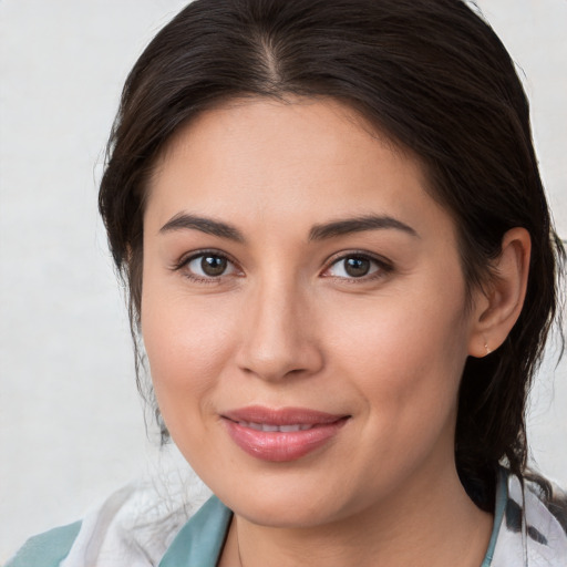 Joyful white young-adult female with medium  brown hair and brown eyes