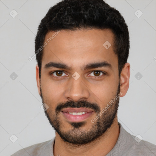 Joyful latino young-adult male with short  black hair and brown eyes