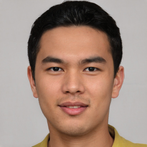 Joyful asian young-adult male with short  black hair and brown eyes