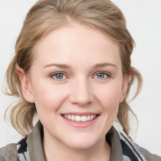 Joyful white young-adult female with medium  brown hair and blue eyes