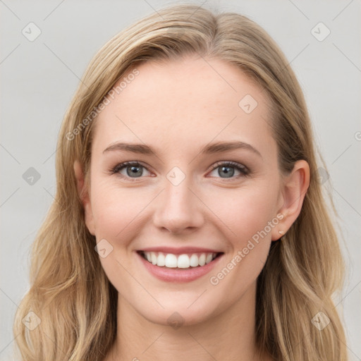 Joyful white young-adult female with long  brown hair and blue eyes