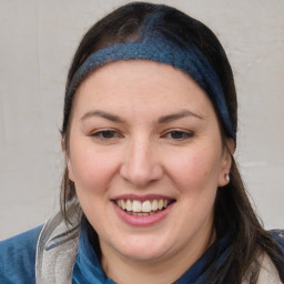 Joyful white young-adult female with medium  brown hair and blue eyes