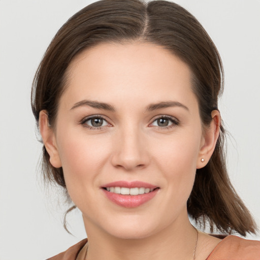 Joyful white young-adult female with medium  brown hair and brown eyes