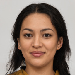 Joyful latino young-adult female with long  brown hair and brown eyes