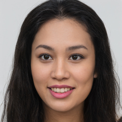 Joyful asian young-adult female with long  brown hair and brown eyes