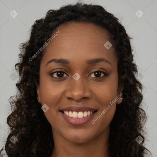 Joyful black young-adult female with long  brown hair and brown eyes