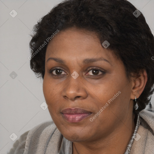 Joyful black adult female with short  brown hair and brown eyes