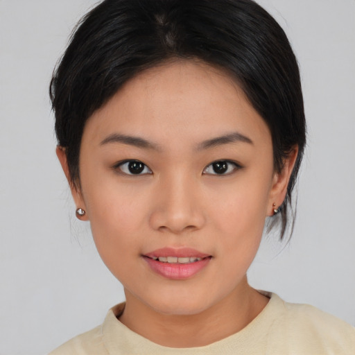 Joyful asian young-adult female with medium  brown hair and brown eyes