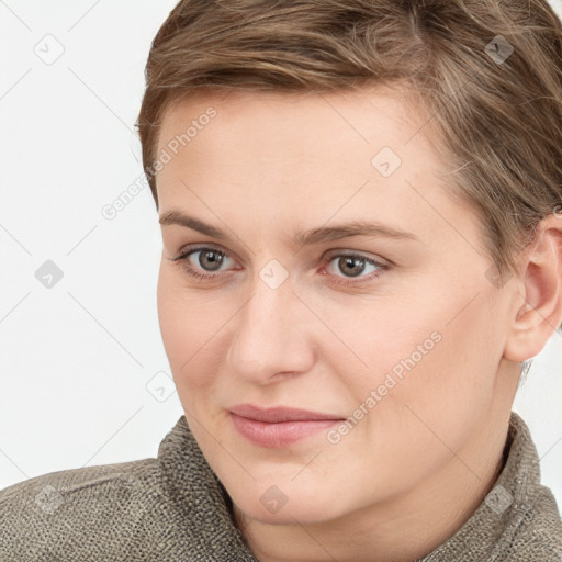 Joyful white young-adult female with short  brown hair and grey eyes