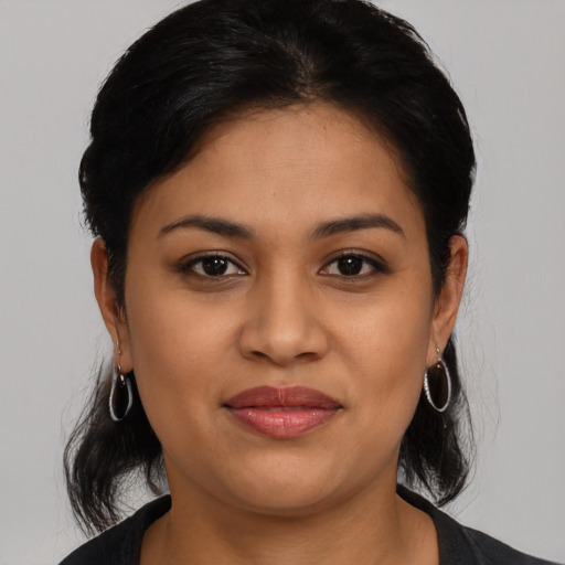 Joyful latino young-adult female with medium  black hair and brown eyes