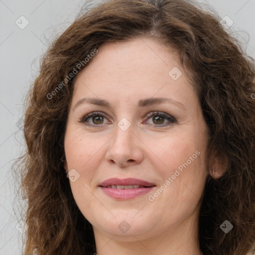 Joyful white adult female with long  brown hair and brown eyes