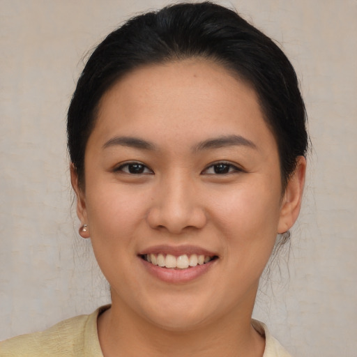 Joyful asian young-adult female with medium  brown hair and brown eyes