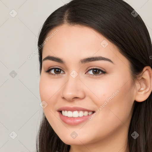 Joyful white young-adult female with long  brown hair and brown eyes