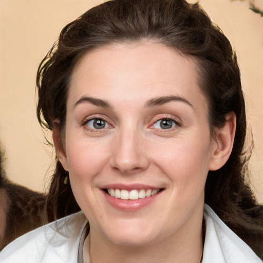 Joyful white young-adult female with medium  brown hair and green eyes