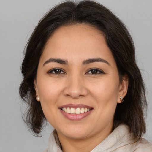 Joyful white young-adult female with medium  brown hair and brown eyes