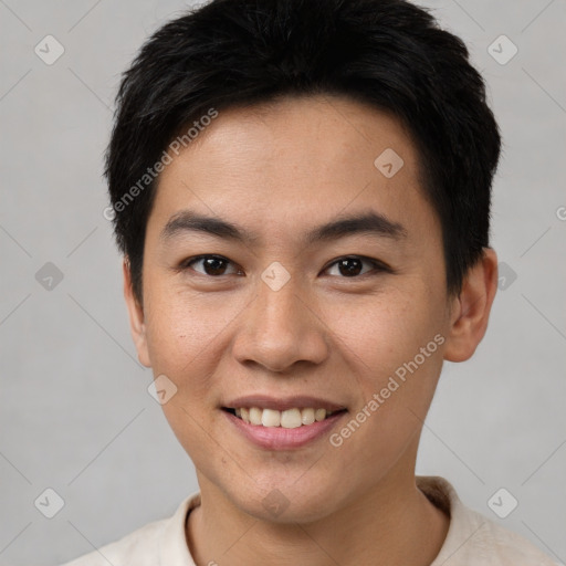 Joyful asian young-adult male with short  brown hair and brown eyes