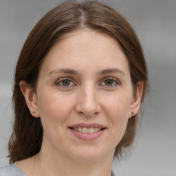 Joyful white young-adult female with medium  brown hair and brown eyes