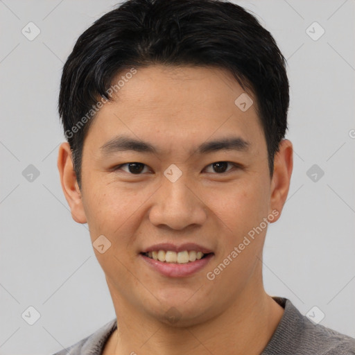 Joyful asian young-adult male with short  black hair and brown eyes