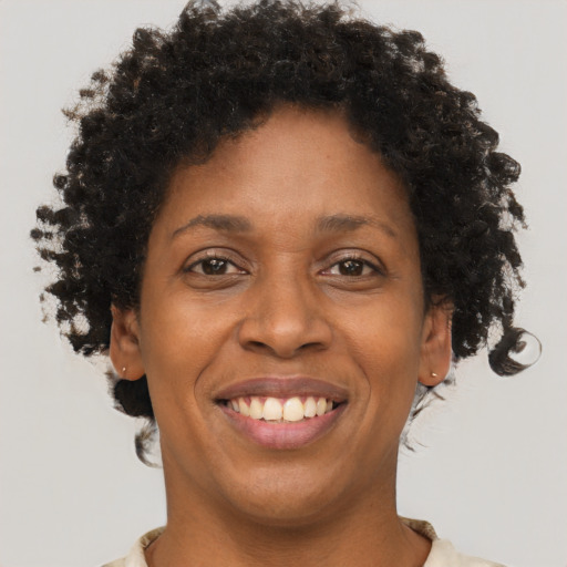 Joyful black young-adult female with short  brown hair and brown eyes