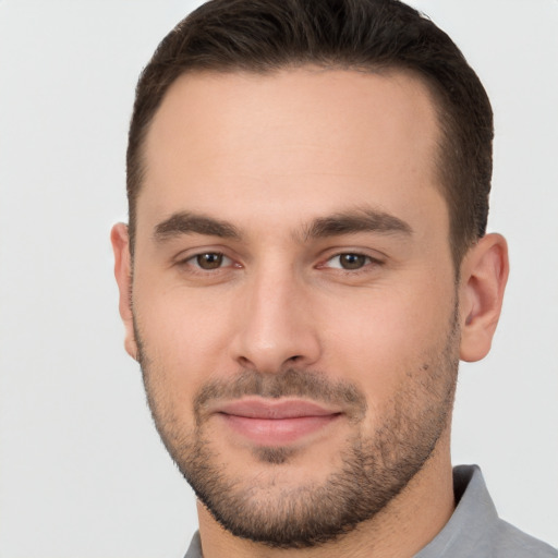 Joyful white young-adult male with short  brown hair and brown eyes