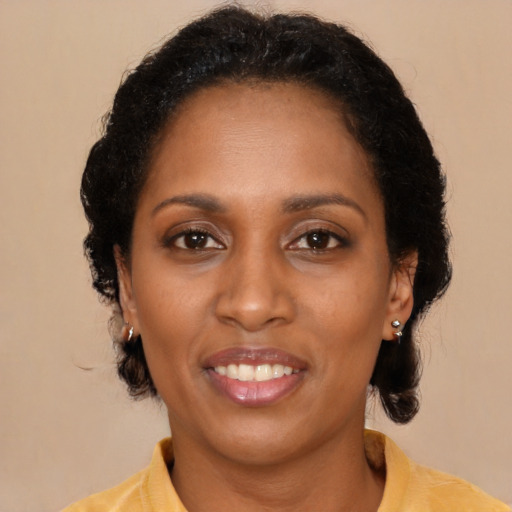 Joyful black young-adult female with medium  black hair and brown eyes