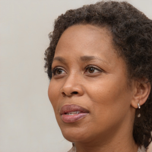 Joyful black adult female with short  brown hair and brown eyes