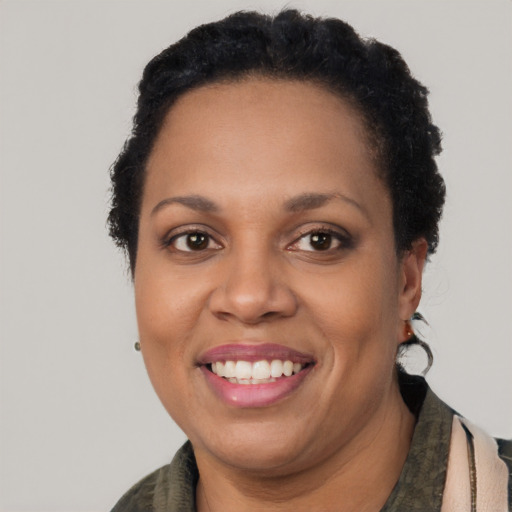 Joyful latino adult female with short  brown hair and brown eyes