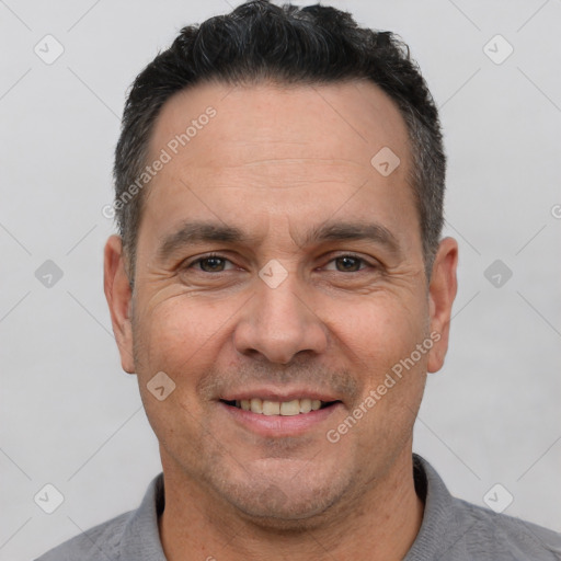 Joyful white adult male with short  brown hair and brown eyes