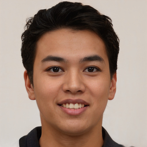 Joyful latino young-adult male with short  brown hair and brown eyes