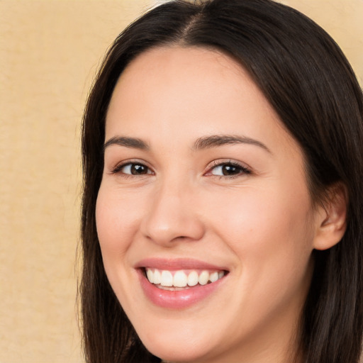 Joyful white young-adult female with long  brown hair and brown eyes