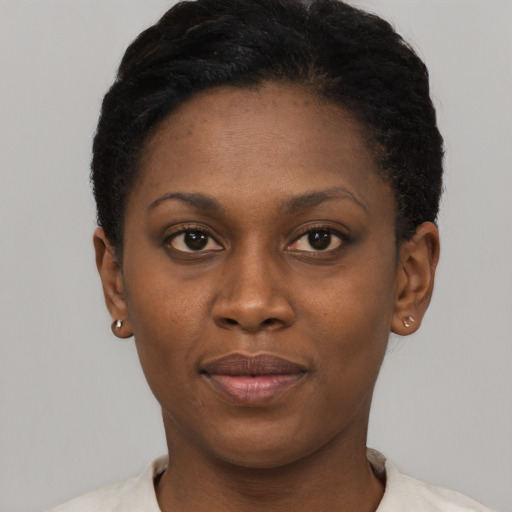 Joyful black young-adult female with short  black hair and brown eyes