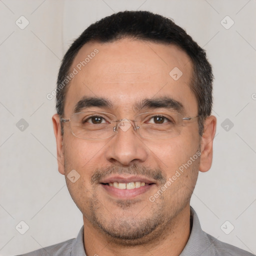 Joyful white adult male with short  black hair and brown eyes