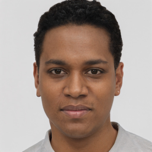 Joyful black young-adult male with short  black hair and brown eyes