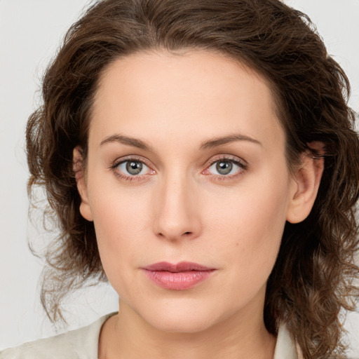 Joyful white young-adult female with medium  brown hair and green eyes