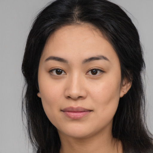 Joyful asian young-adult female with long  black hair and brown eyes