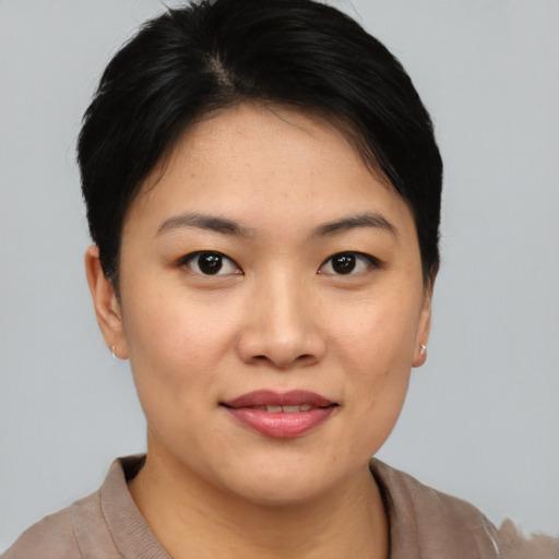 Joyful asian young-adult female with short  black hair and brown eyes