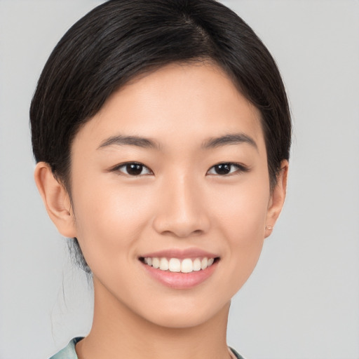 Joyful asian young-adult female with short  brown hair and brown eyes