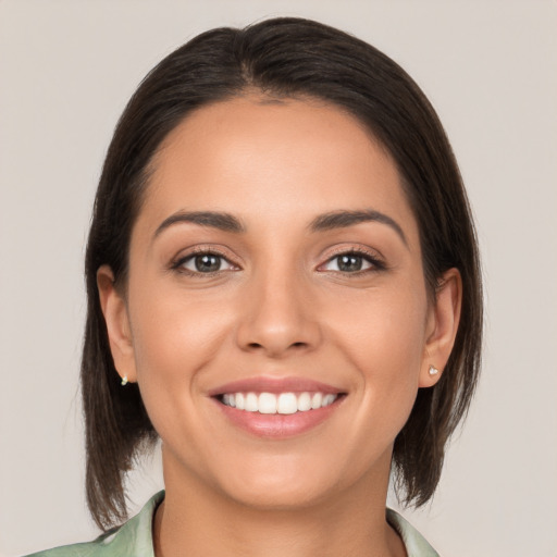 Joyful white young-adult female with medium  brown hair and brown eyes