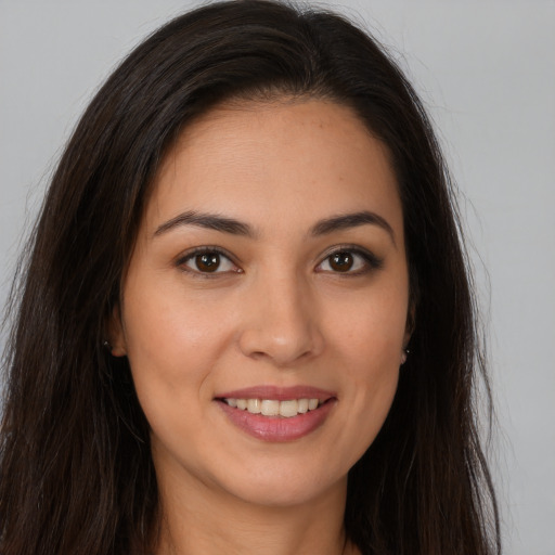 Joyful white young-adult female with long  brown hair and brown eyes