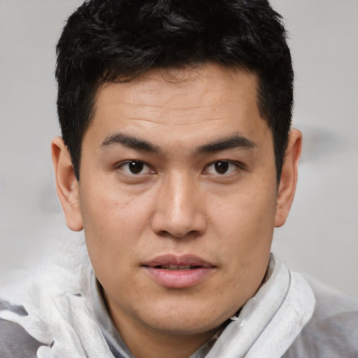 Joyful latino young-adult male with short  brown hair and brown eyes