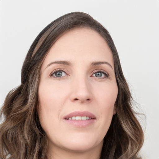 Joyful white young-adult female with long  brown hair and green eyes