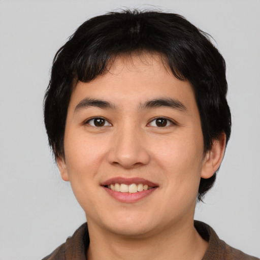 Joyful asian young-adult male with medium  brown hair and brown eyes