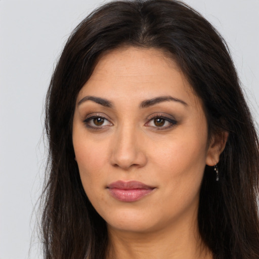 Joyful latino young-adult female with long  brown hair and brown eyes