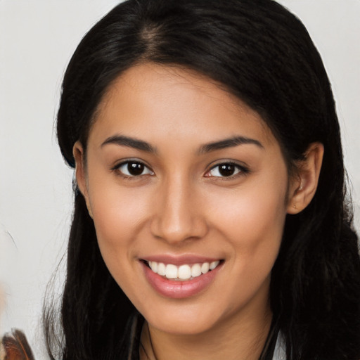 Joyful latino young-adult female with long  brown hair and brown eyes