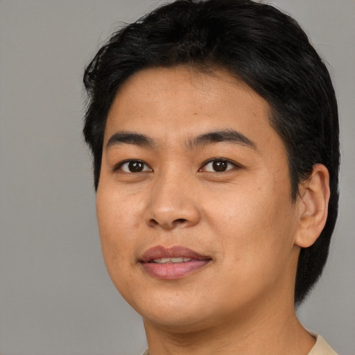 Joyful asian young-adult male with short  black hair and brown eyes
