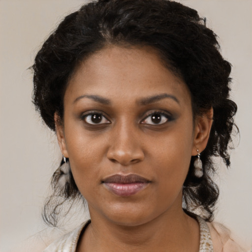 Joyful black young-adult female with medium  brown hair and brown eyes