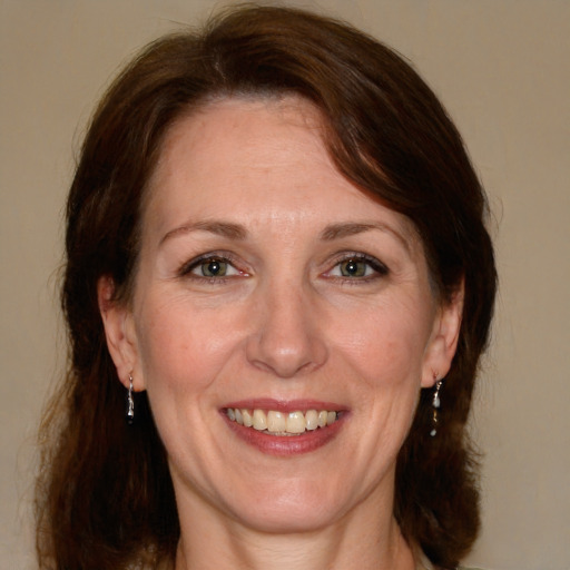 Joyful white adult female with medium  brown hair and grey eyes