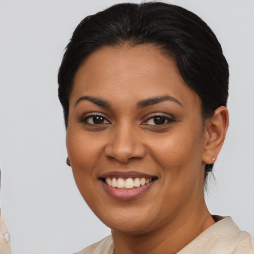 Joyful latino young-adult female with short  brown hair and brown eyes