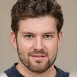 Joyful white adult male with short  brown hair and grey eyes