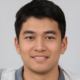 Joyful asian young-adult male with short  brown hair and brown eyes